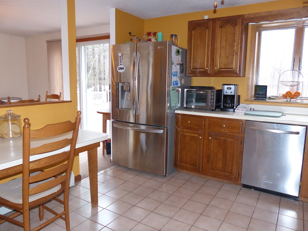 86 Highland Road Merrimac, MA 01860 - Photo 6 of 12 a kitchen with stainless steel appliances granite countertop a refrigerator and a sink