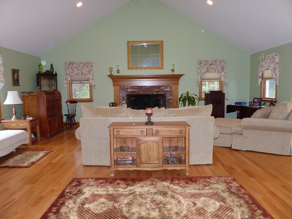 86 Highland Road Merrimac, MA 01860 - Photo 9 of 12 a living room with furniture a fireplace and a table