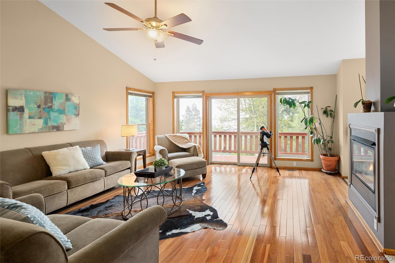 11163 Conifer Mountain Road Conifer, CO 80433 - Photo 12 of 46 a living room with furniture large windows and wooden floor