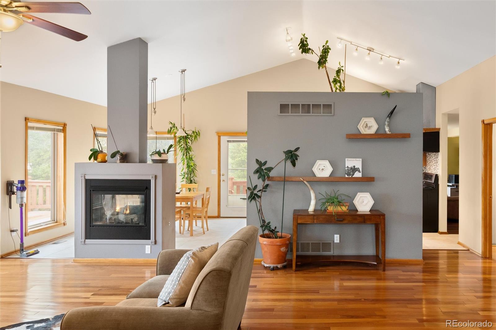11163 Conifer Mountain Road Conifer, CO 80433 - Photo 13 of 46 a living room with furniture and a fireplace