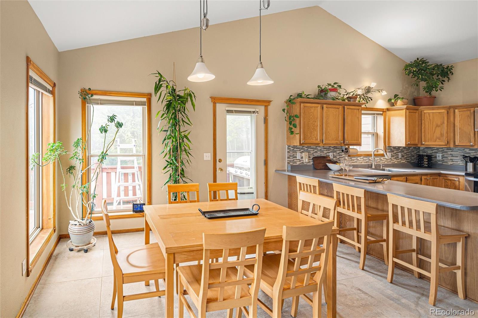 11163 Conifer Mountain Road Conifer, CO 80433 - Photo 19 of 46 a dining table chairs and a chandelier
