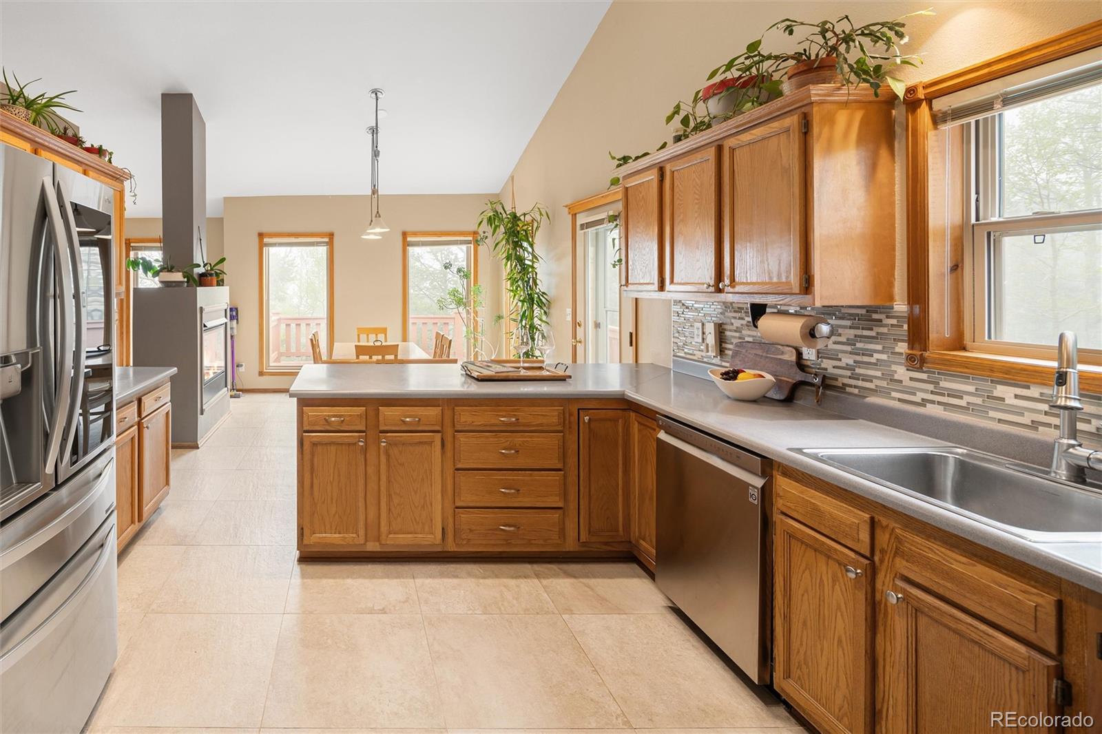 11163 Conifer Mountain Road Conifer, CO 80433 - Photo 21 of 46 a kitchen with stainless steel appliances a sink window and cabinets