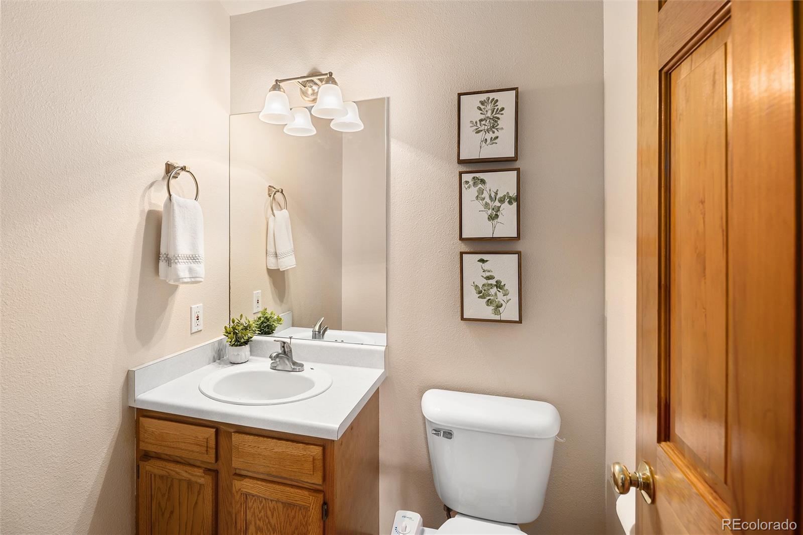 11163 Conifer Mountain Road Conifer, CO 80433 - Photo 23 of 46 a bathroom with a toilet sink and mirror