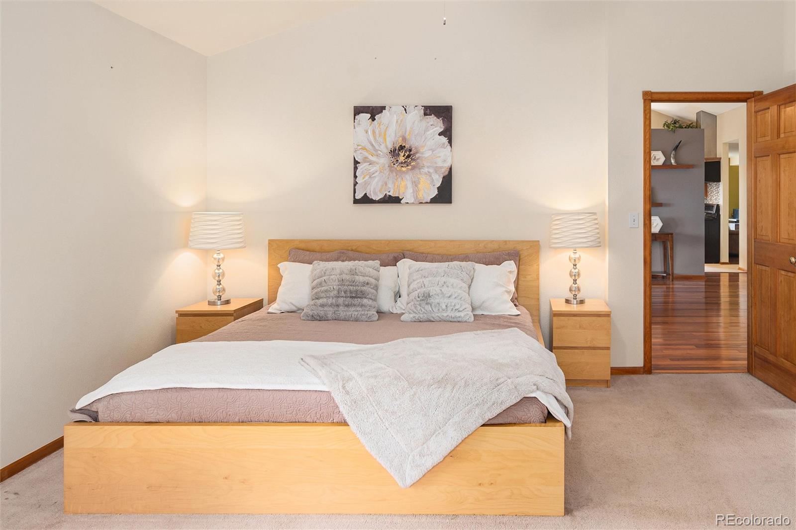 11163 Conifer Mountain Road Conifer, CO 80433 - Photo 24 of 46 a bedroom with a bed and a painting on the wall