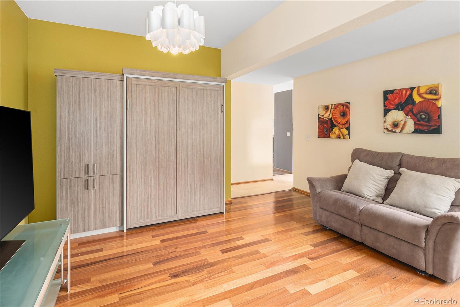 11163 Conifer Mountain Road Conifer, CO 80433 - Photo 27 of 46 a living room with furniture and a flat screen tv