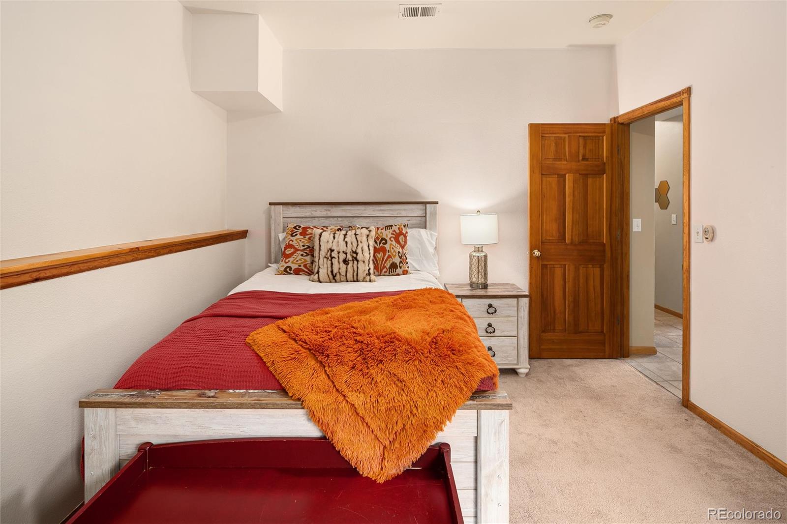 11163 Conifer Mountain Road Conifer, CO 80433 - Photo 29 of 46 a bedroom with a bed and a night stand