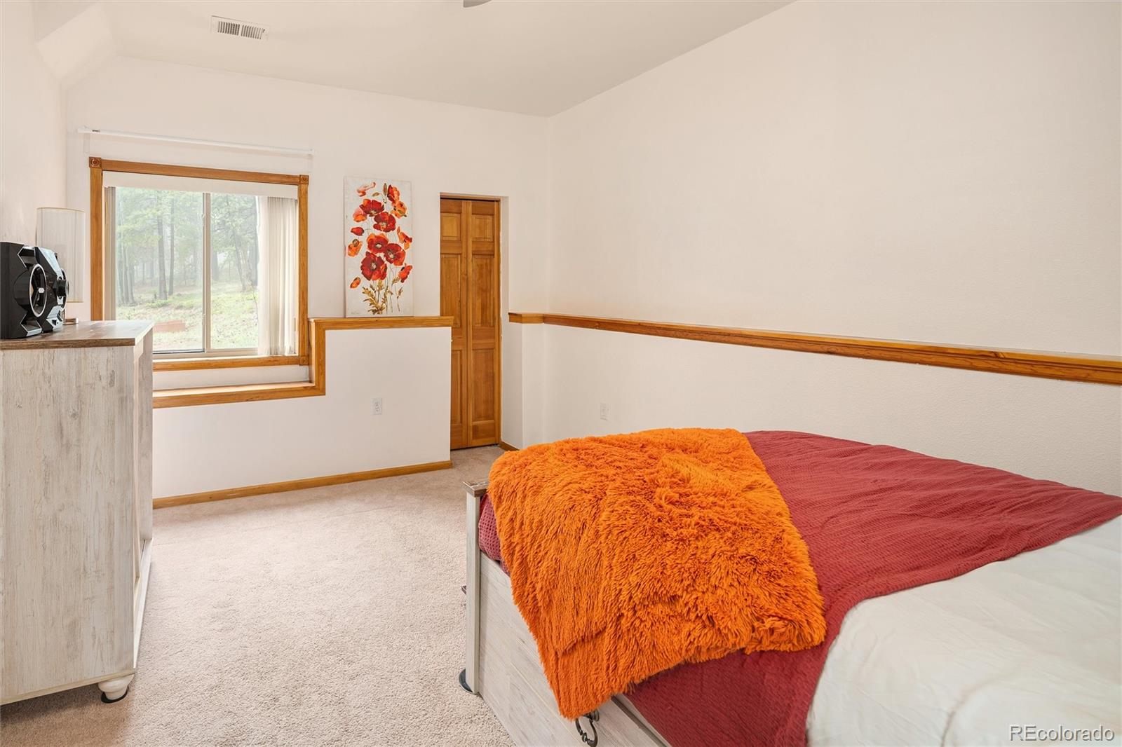 11163 Conifer Mountain Road Conifer, CO 80433 - Photo 30 of 46 a bed sitting in a bedroom next to a window