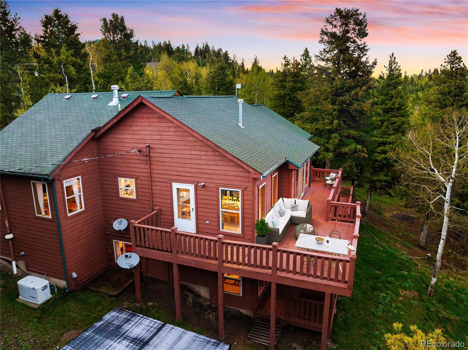 11163 Conifer Mountain Road Conifer, CO 80433 - Photo 32 of 46 a front view of a house with garden