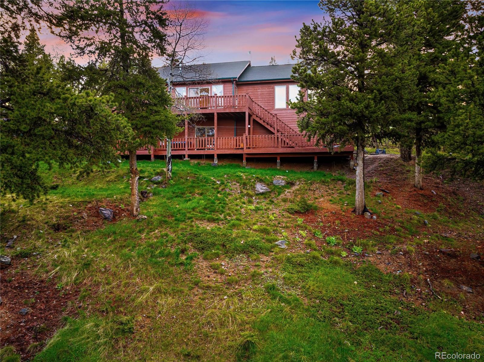 11163 Conifer Mountain Road Conifer, CO 80433 - Photo 41 of 46 a view of a house with a back yard