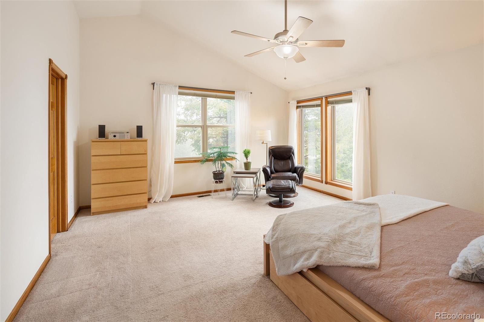 11163 Conifer Mountain Road Conifer, CO 80433 - Photo 6 of 46 a bedroom with furniture and a large window