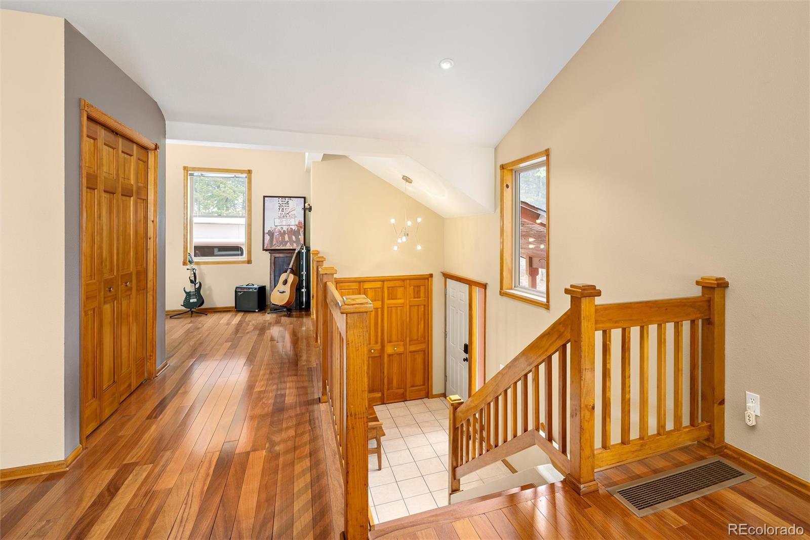 11163 Conifer Mountain Road Conifer, CO 80433 - Photo 8 of 46 a view of a room with wooden floor and stairs