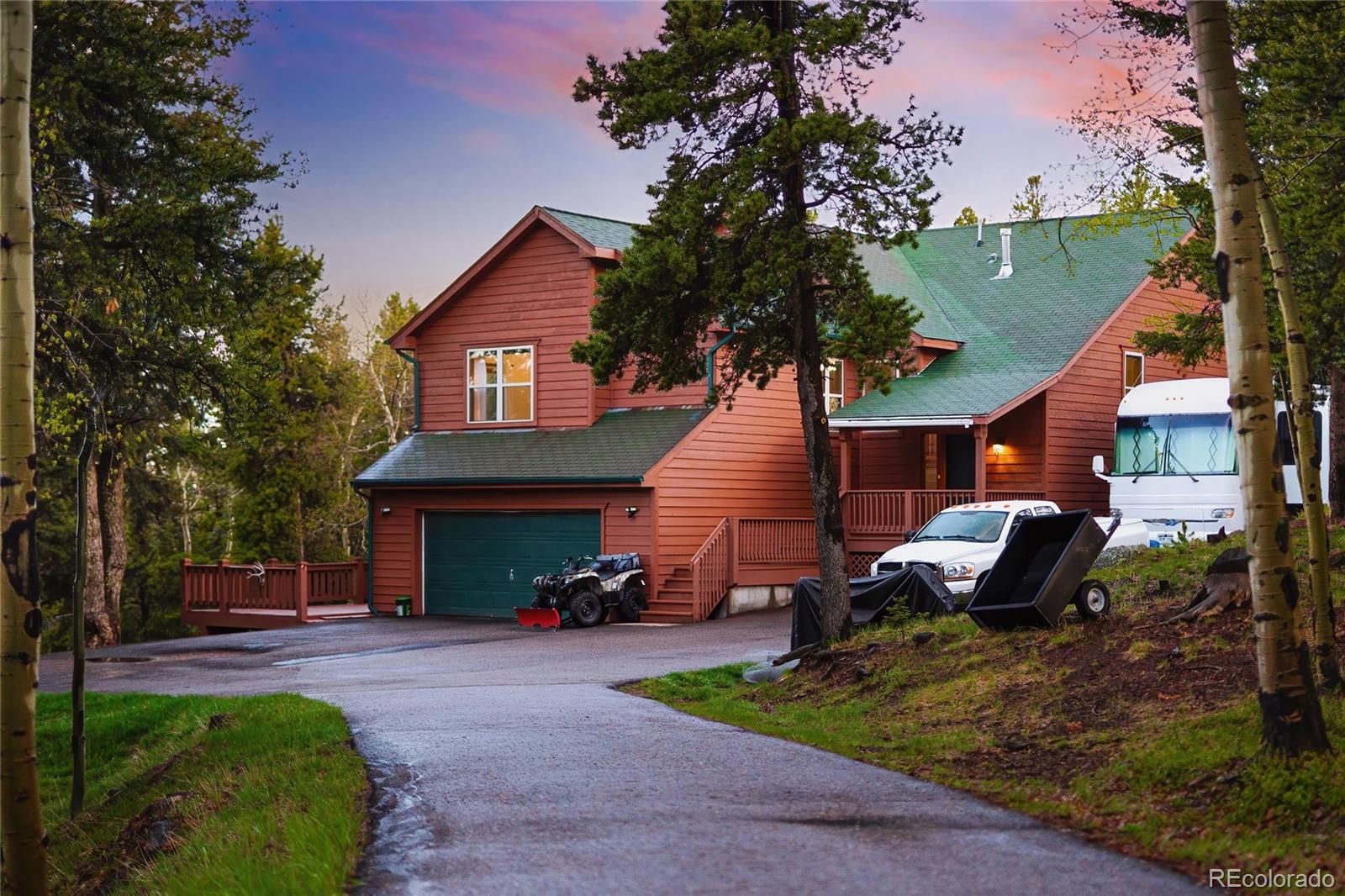 11163 Conifer Mountain Road Conifer, CO 80433 - Photo 10 of 46 a front view of a house with a garden