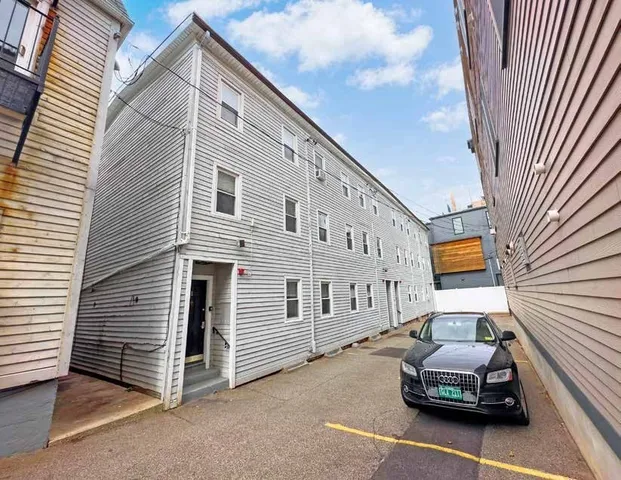 a kitchen with a refrigerator a stove a sink cabinets and a dining table