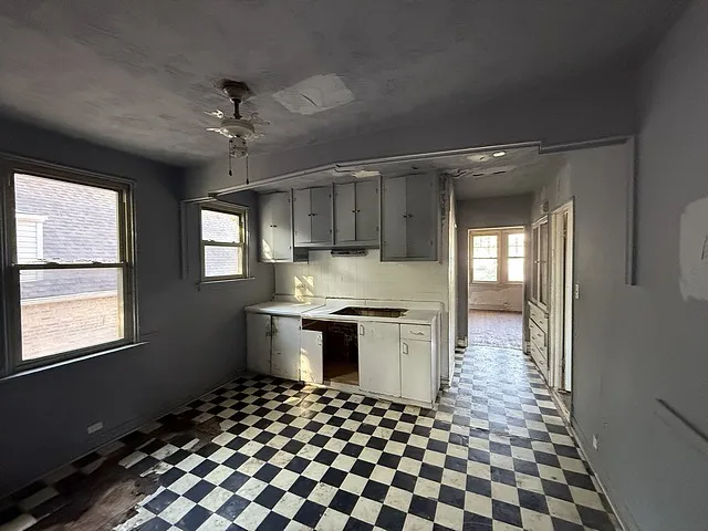 a kitchen with granite countertop stainless steel appliances a stove a sink and a window