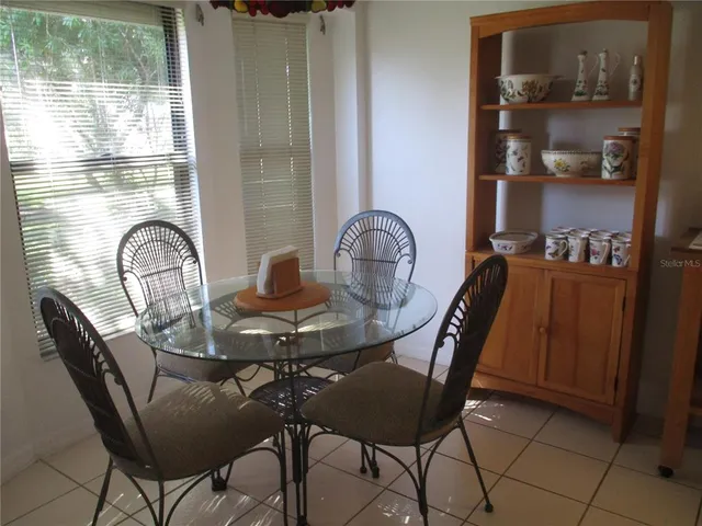 a dining room with furniture and window