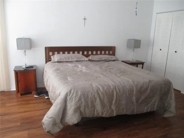 a bed sitting in a bedroom next to a lamp