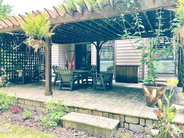 a view of a backyard with plants and outdoor seating