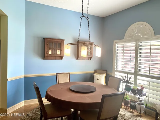 a dining room with furniture and window