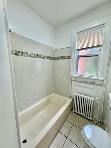 a bathroom with a sink a mirror and a bathtub