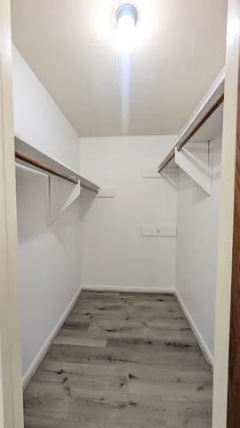 a view of hallway with wooden floor