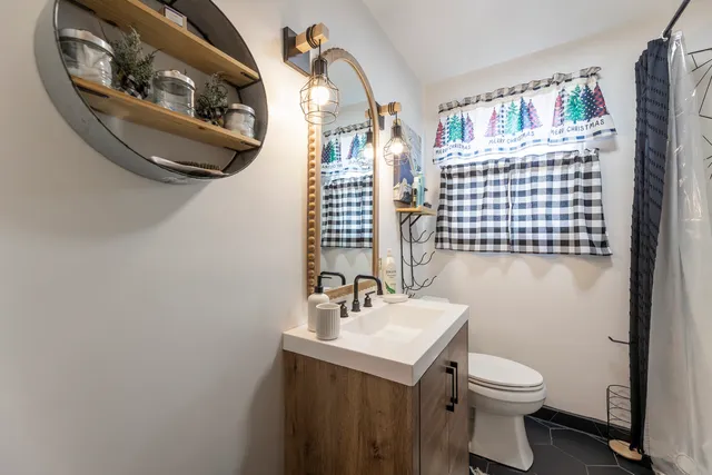 a bathroom with a sink a toilet and mirror