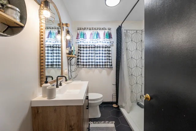 a bathroom with a sink toilet and shower