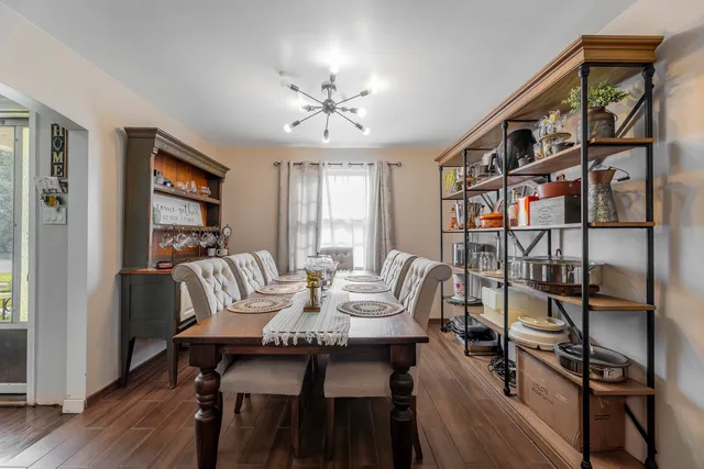 a view of a dining room with furniture window and wooden floor