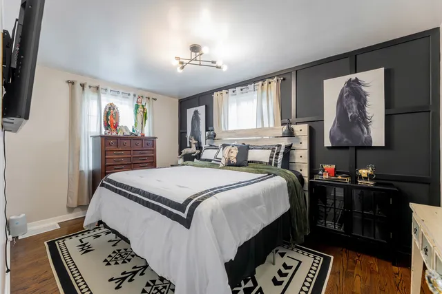 a bed room with a bed and a television