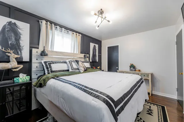 a bedroom with a bed and a chandelier