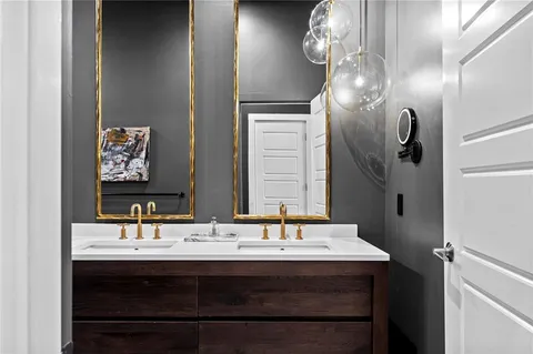 a kitchen with stainless steel appliances granite countertop a sink a stove and chairs