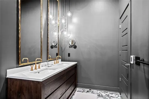 a kitchen with stainless steel appliances granite countertop a kitchen island a table and chairs in it