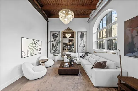 a kitchen with stainless steel appliances granite countertop a table chairs and a wooden floor