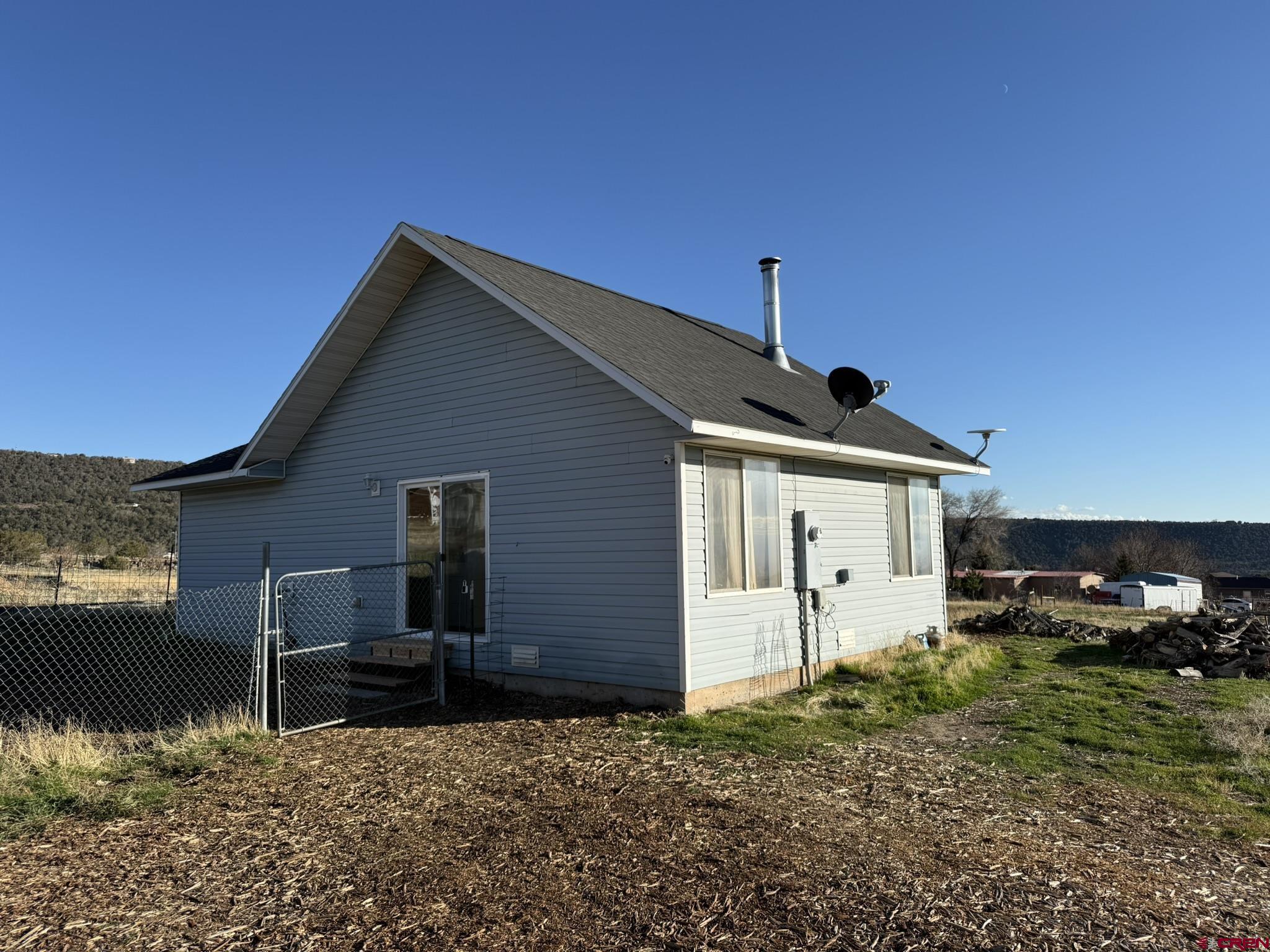 18358 Surface Creek Road Cedaredge, CO 81413 - Photo 13 of 26 a backyard of a house with lots of green space