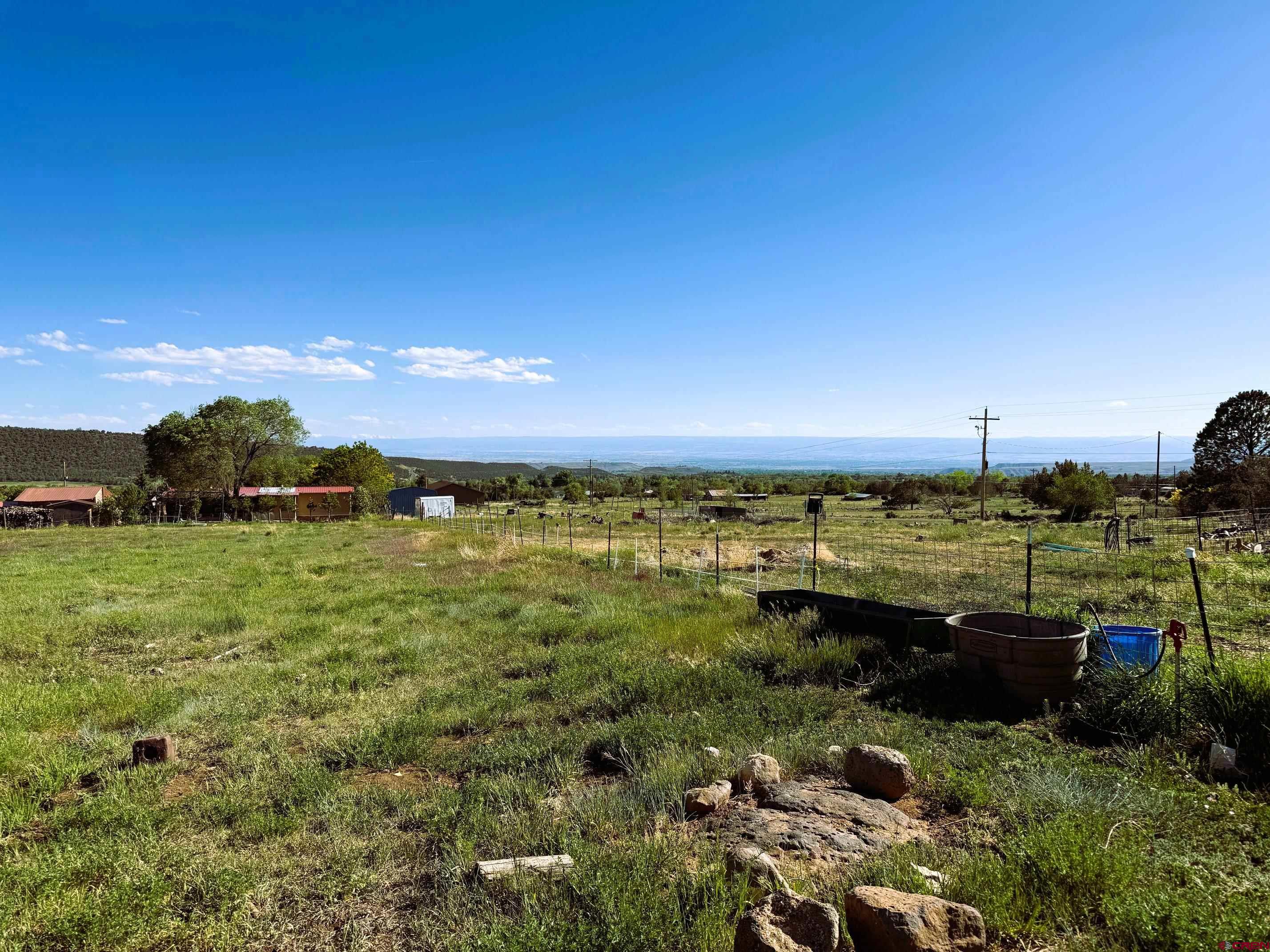 18358 Surface Creek Road Cedaredge, CO 81413 - Photo 2 of 26 a view of a lake with houses