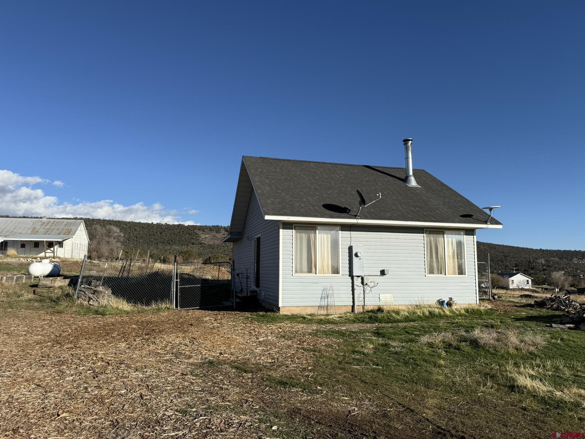 18358 Surface Creek Road Cedaredge, CO 81413 - Photo 21 of 26 a front view of a house with a yard