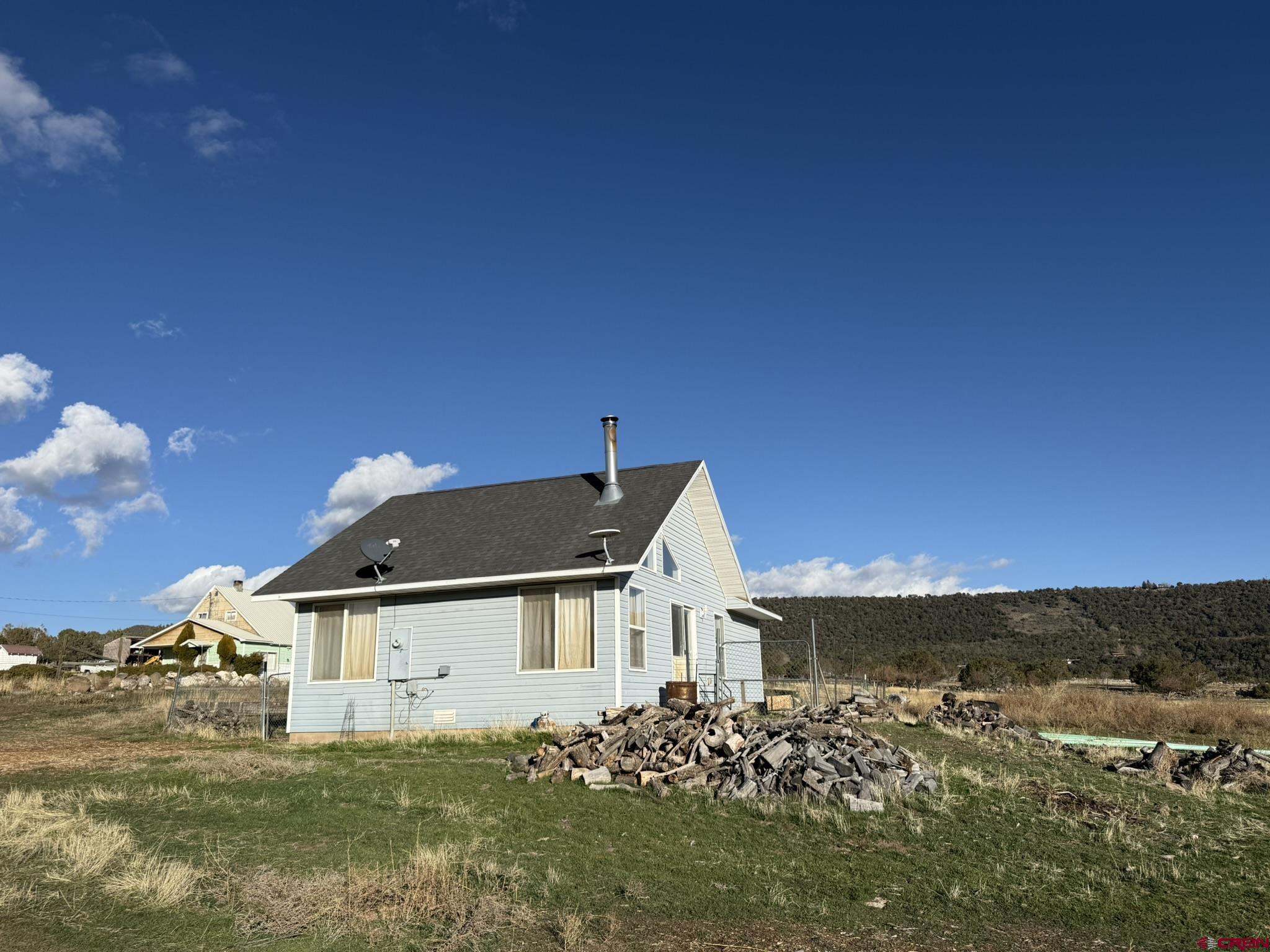 18358 Surface Creek Road Cedaredge, CO 81413 - Photo 22 of 26 a view of a house with a big yard
