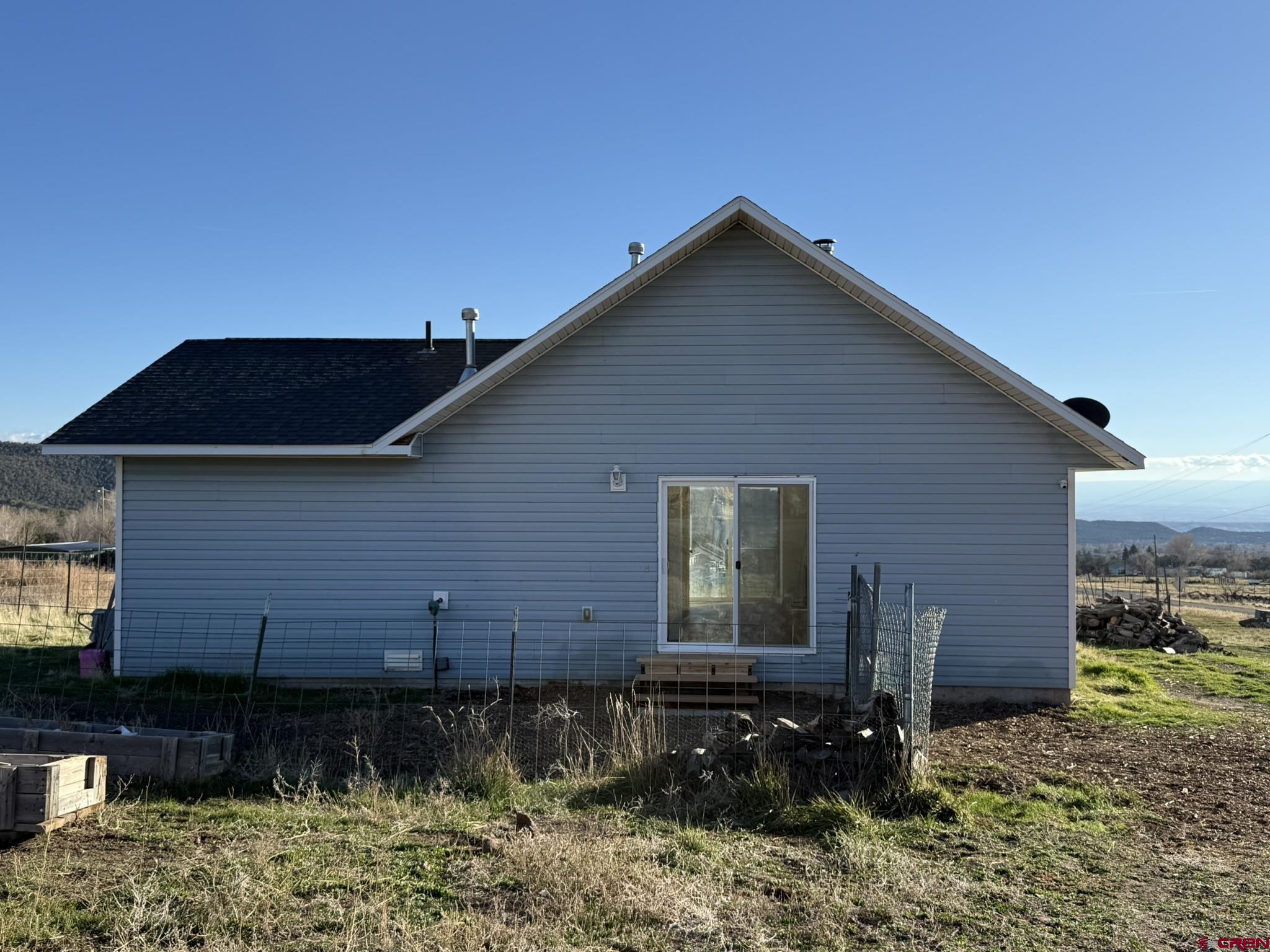 18358 Surface Creek Road Cedaredge, CO 81413 - Photo 24 of 26 a backyard of a house with lots of green space