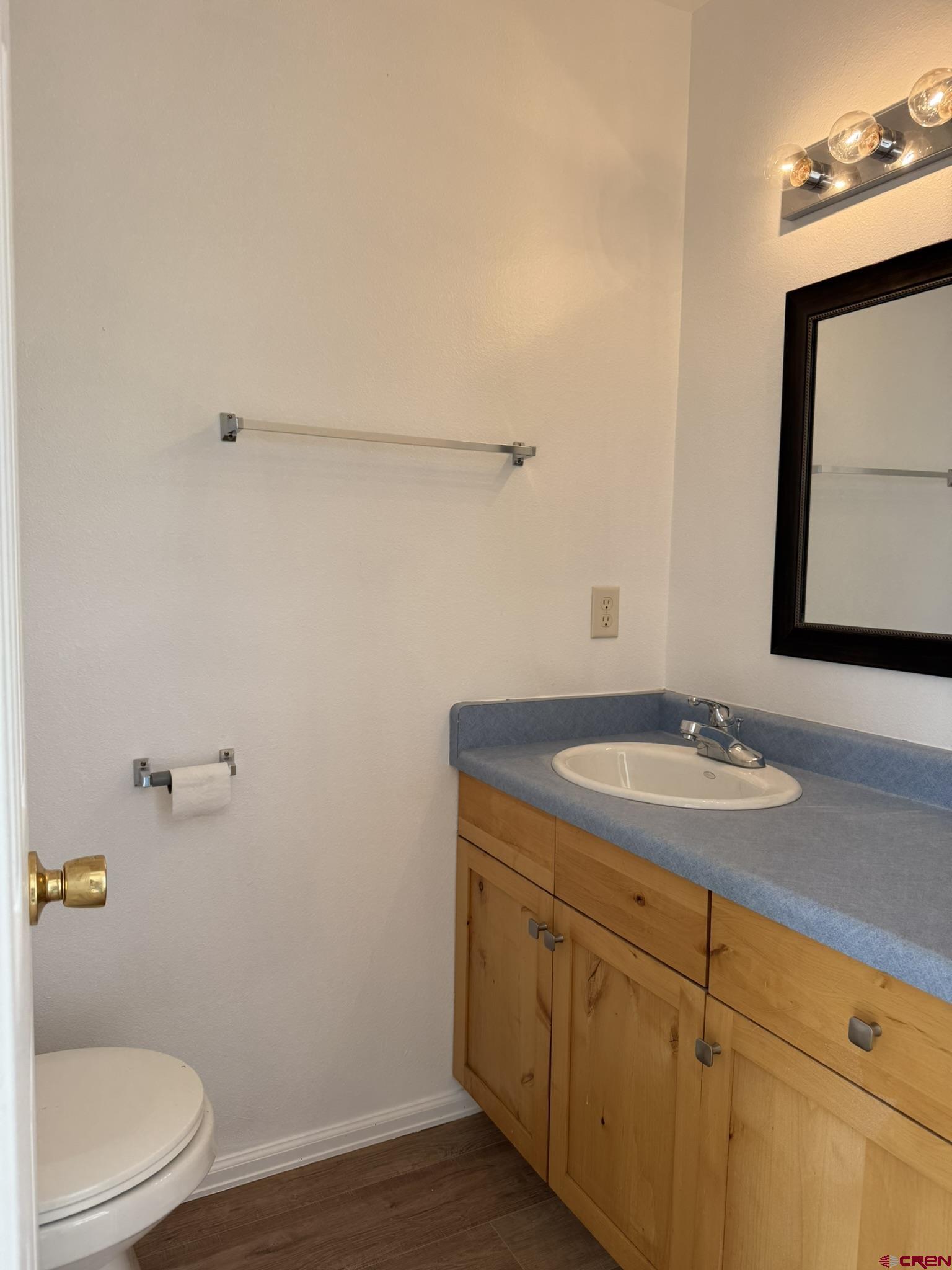 18358 Surface Creek Road Cedaredge, CO 81413 - Photo 5 of 26 a bathroom with a granite countertop sink a toilet and mirror