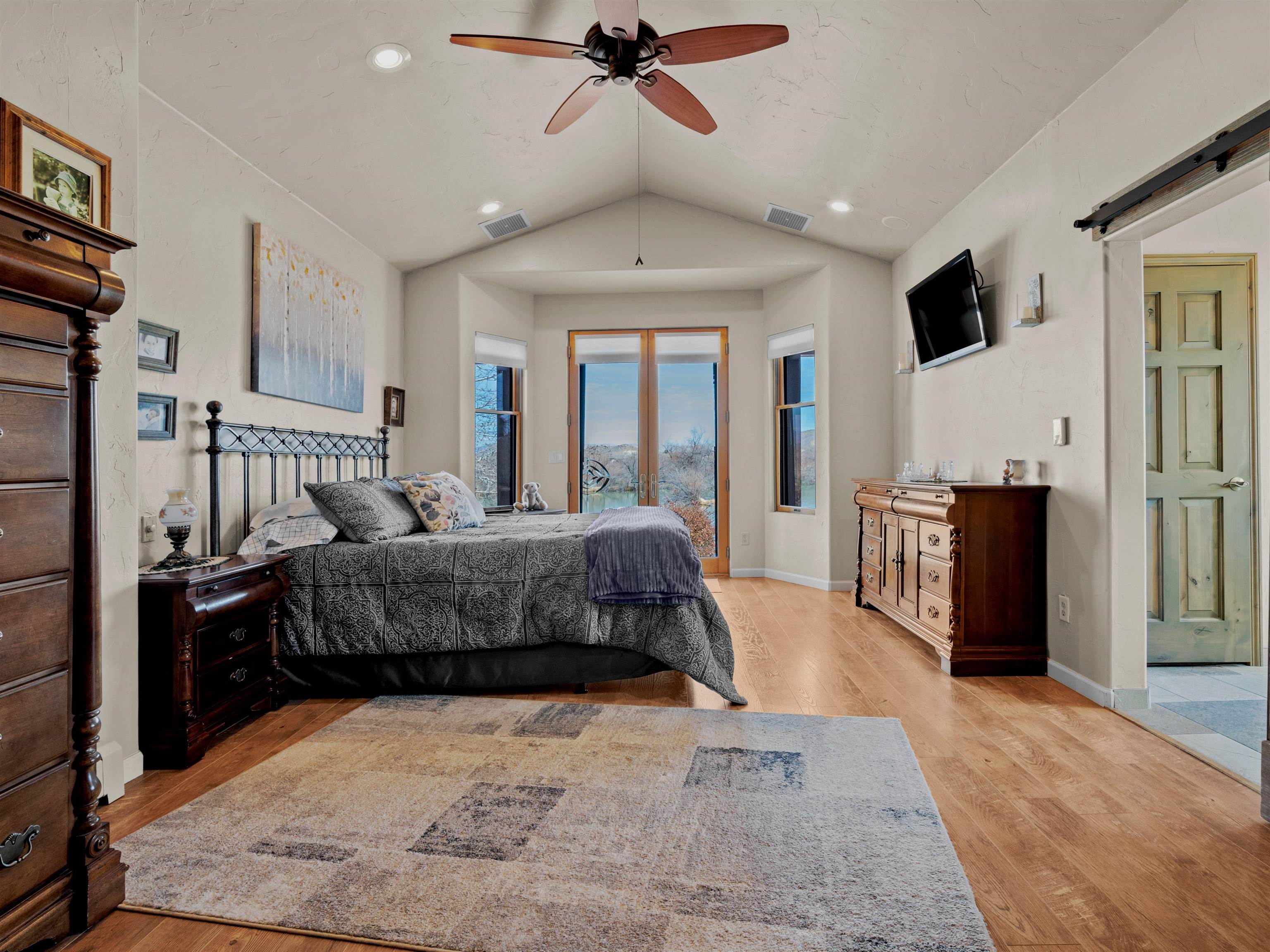 2111 Desert Hill Road Grand Junction, CO 81507 - Photo 17 of 34 a bedroom with a large bed and a flat screen tv