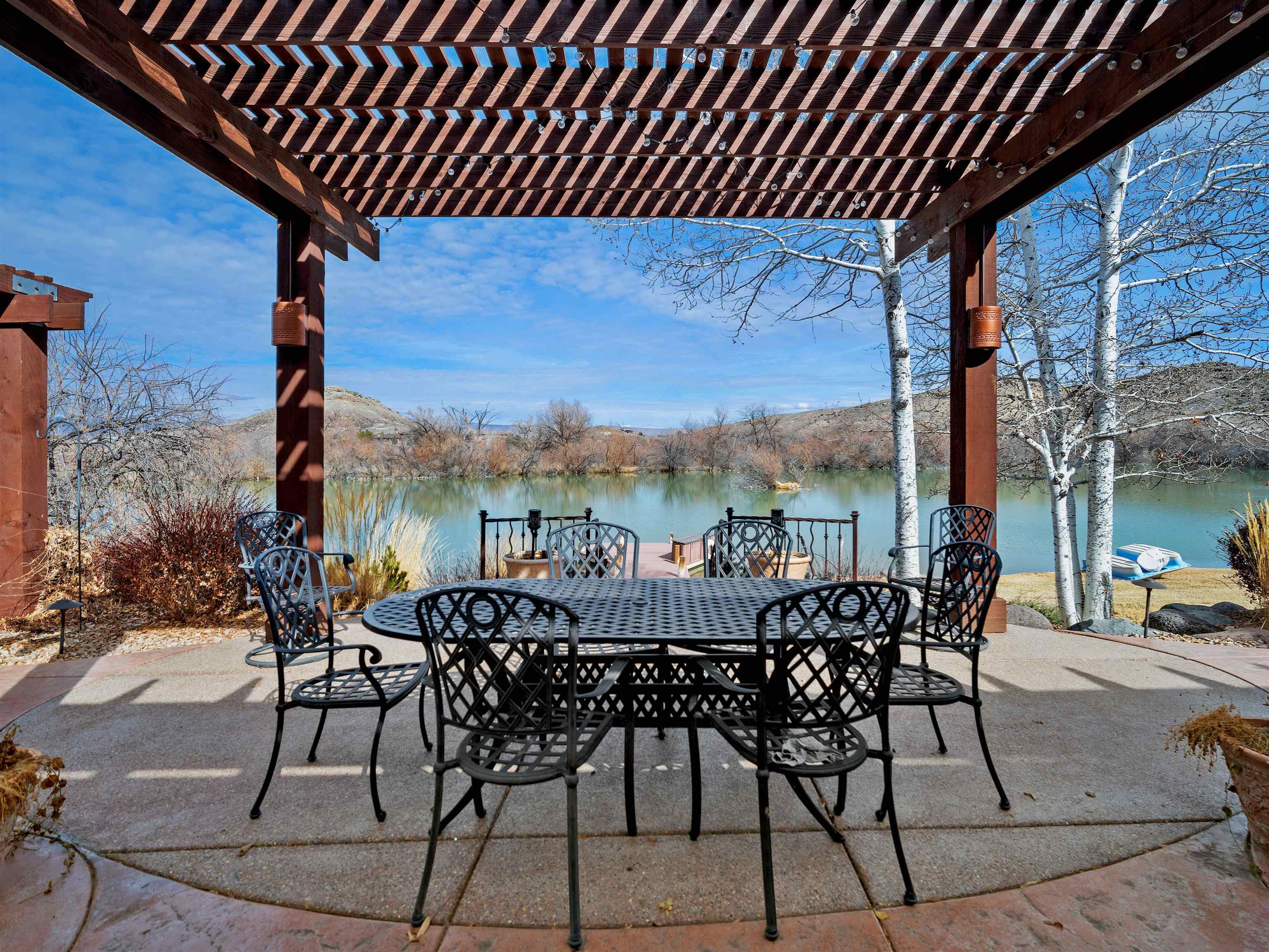 2111 Desert Hill Road Grand Junction, CO 81507 - Photo 26 of 34 a view of a patio with table and chairs and wooden floor
