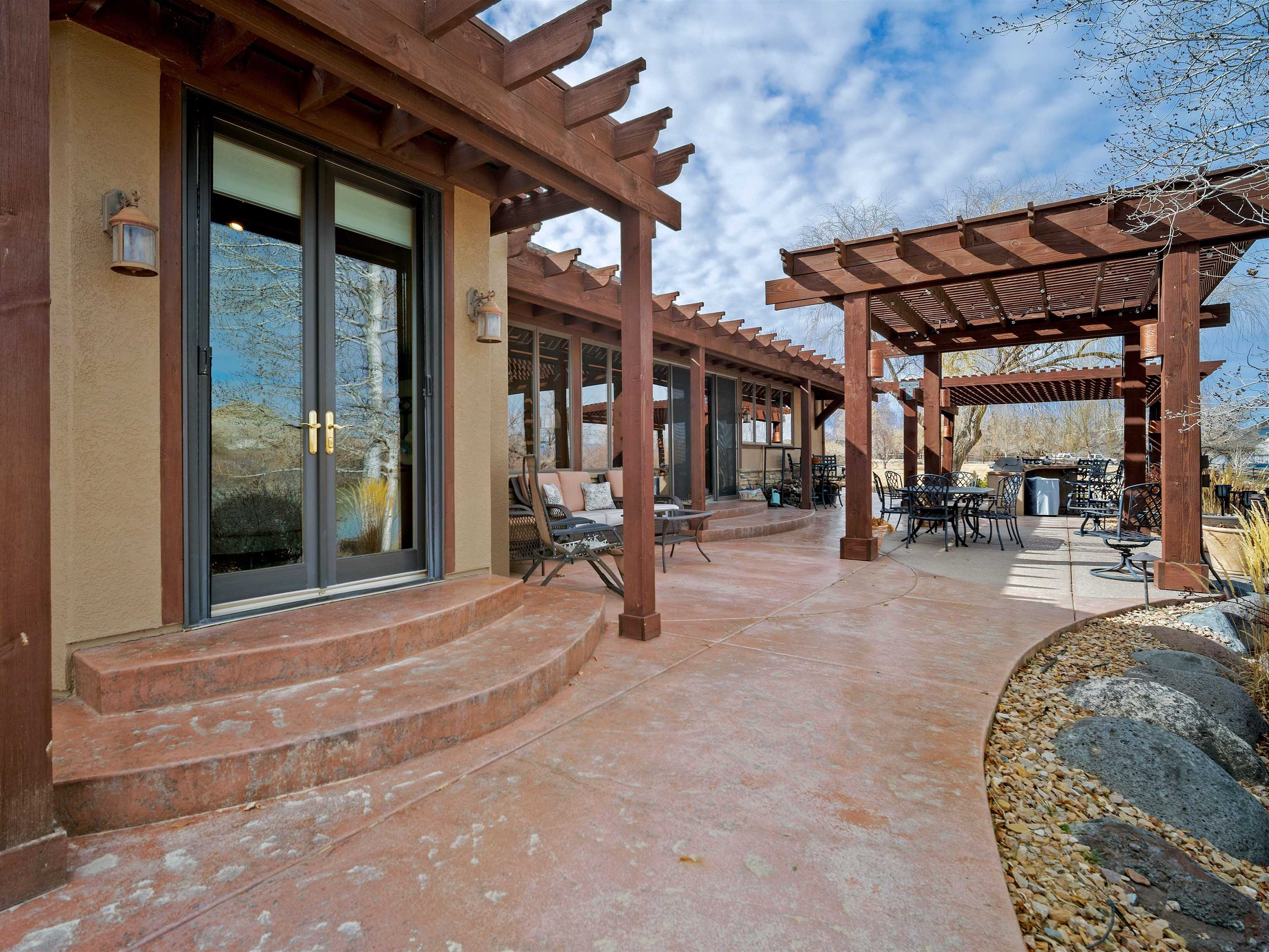 2111 Desert Hill Road Grand Junction, CO 81507 - Photo 28 of 34 a view of a chairs and table in patio with a barbeque