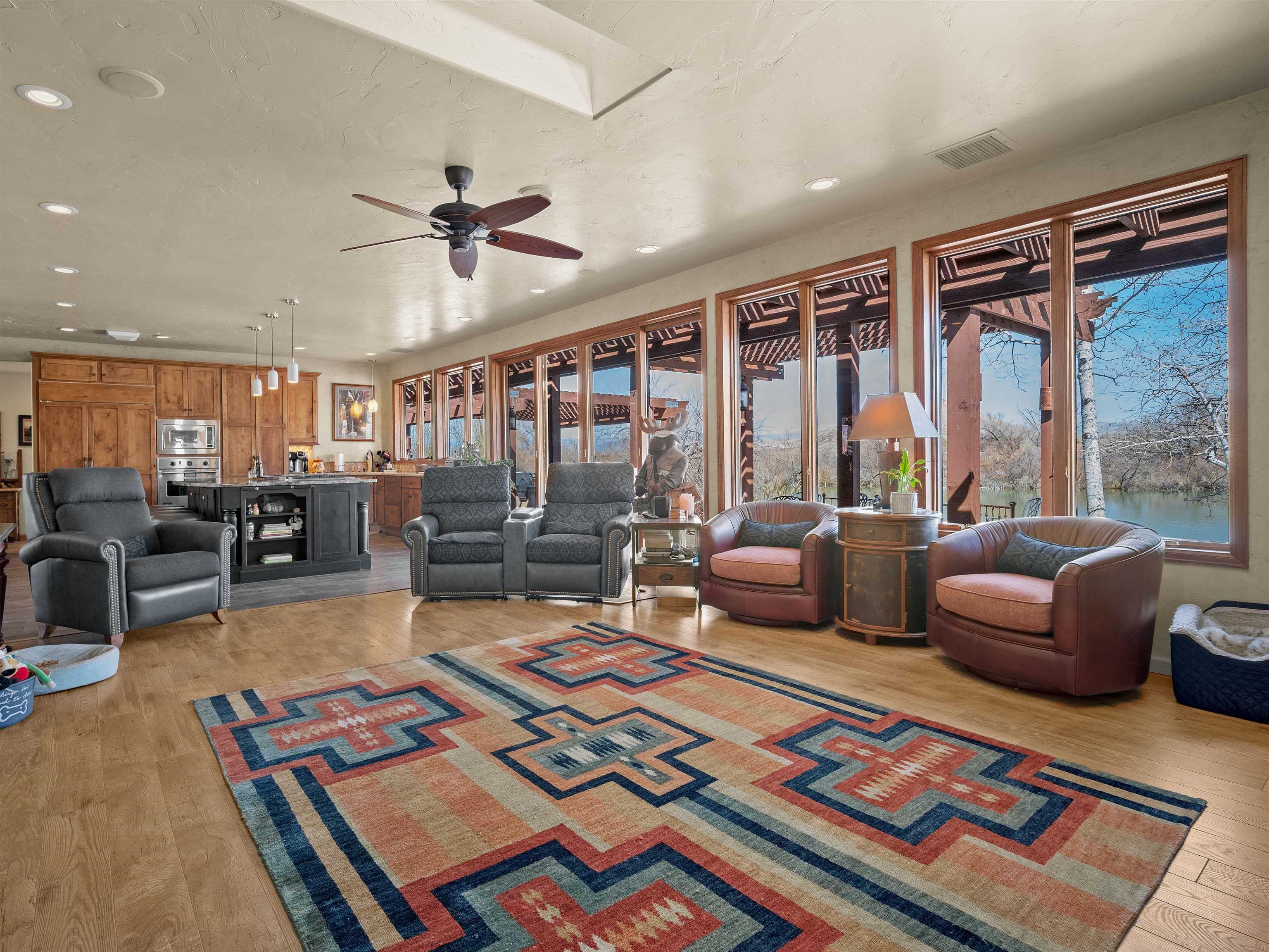 2111 Desert Hill Road Grand Junction, CO 81507 - Photo 9 of 34 a living room with furniture a rug and a floor to ceiling window