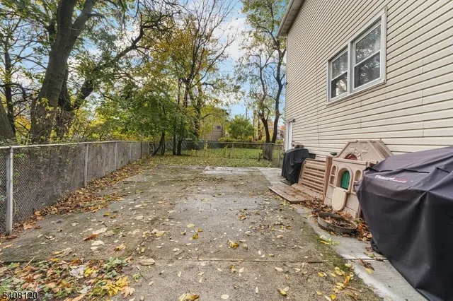 a view of a backyard with chairs