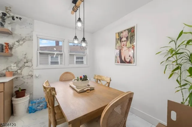 a view of a workspace with furniture and chandelier