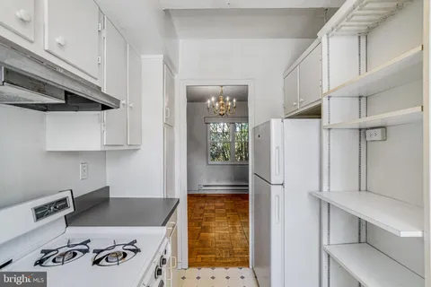 a kitchen with stainless steel appliances granite countertop a refrigerator and a stove