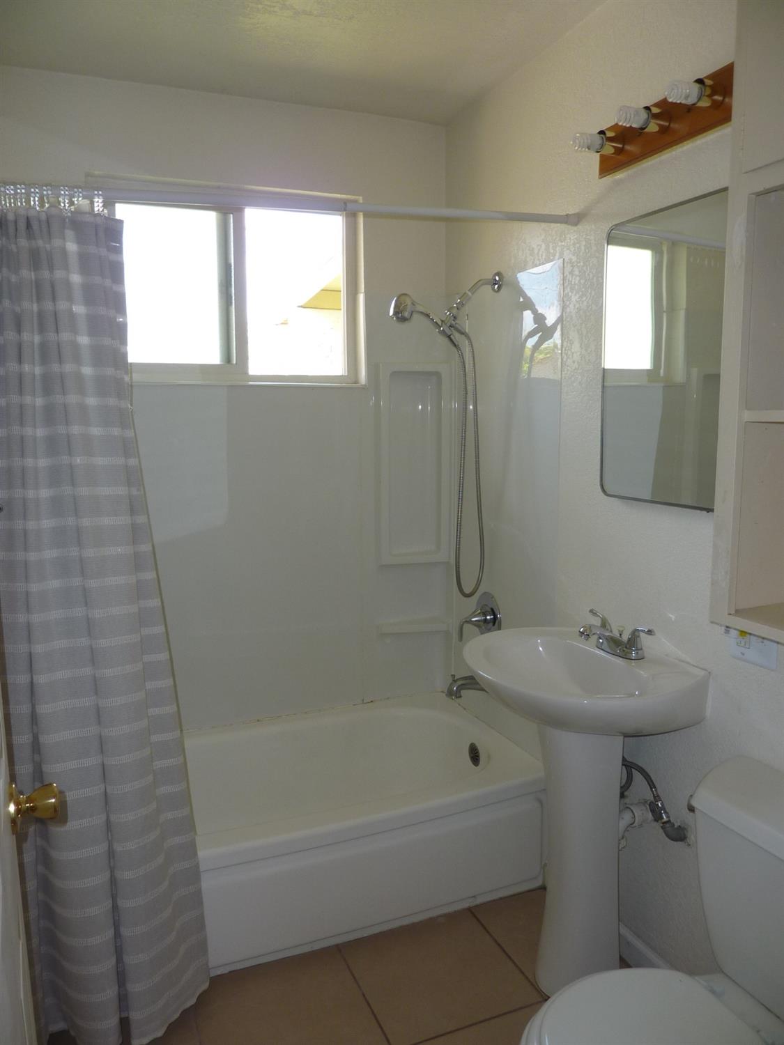 2629 East Richert Avenue Fresno, CA 93726 - Photo 15 of 32 a bathroom with a sink toilet and shower