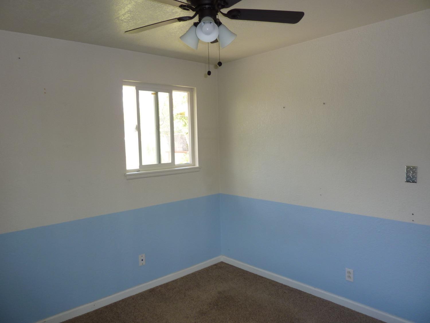 2629 East Richert Avenue Fresno, CA 93726 - Photo 18 of 32 an empty room with a window