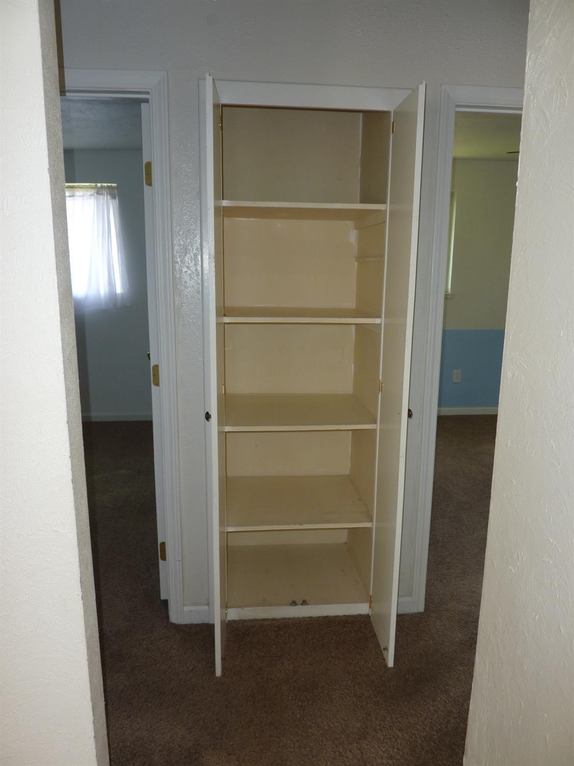 2629 East Richert Avenue Fresno, CA 93726 - Photo 19 of 32 a view of walk in closet with empty racks
