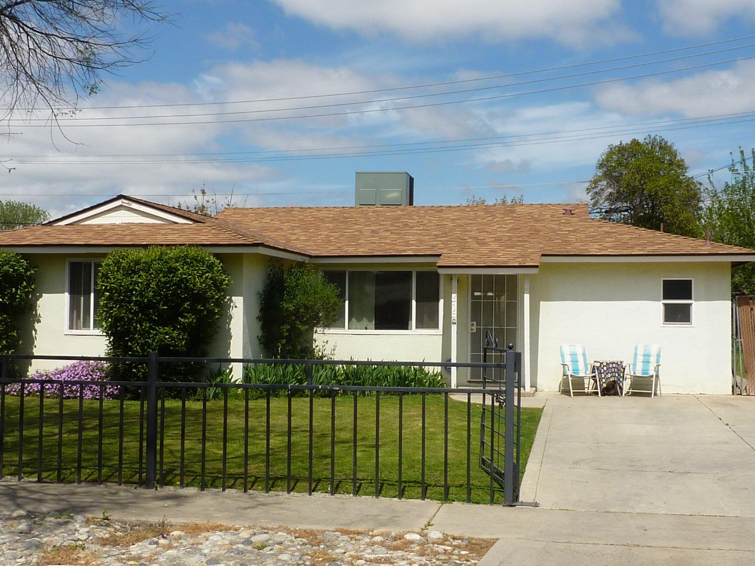 2629 East Richert Avenue Fresno, CA 93726 - Photo 2 of 32 a front view of a house with a garden