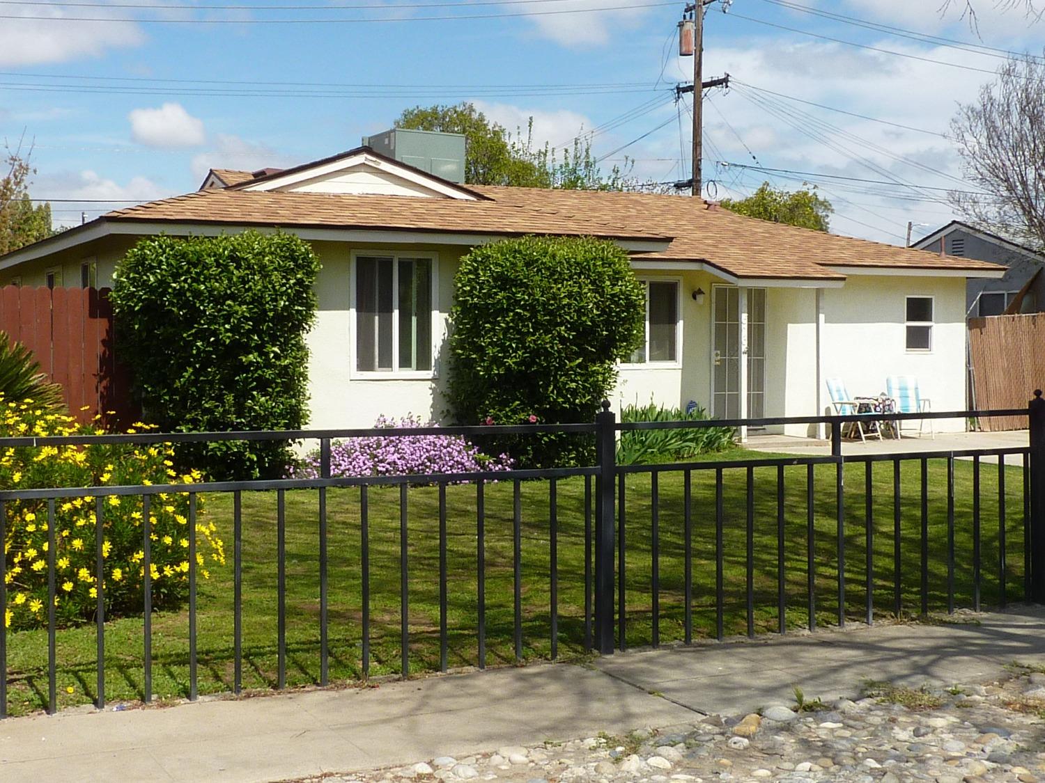 2629 East Richert Avenue Fresno, CA 93726 - Photo 3 of 32 a front view of a house with a garden